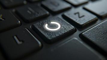 A closeup of a wireless keyboards power button featuring a minimalist design and illuminated by a faint white light photo