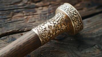 The handle of the mallet is decorated with intricate metallic accents adding a touch of elegance to the functional equipment photo