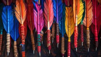 An overhead shot of a quiver filled with brightly colored arrows each one adorned with unique fletching designs and sharp metal arrowheads photo
