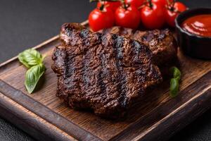 Fresh juicy delicious beef steak on a dark background photo