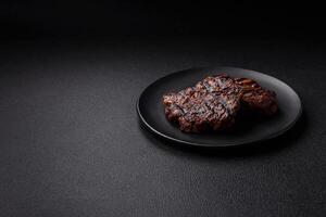Fresh juicy delicious beef steak on a dark background photo