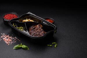 Fresh juicy delicious beef steak on a dark background photo