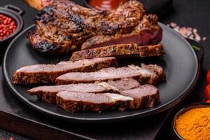 Juicy beef tomahawk steak on the bone baked on the grill photo