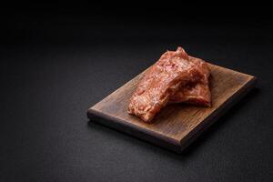 Raw pork or beef ribs in honey sauce with salt, spices photo