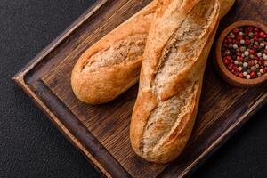 Crispy mini baguette with seeds and grains, salt and spices photo