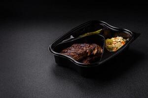 Fresh juicy delicious beef steak on a dark background photo