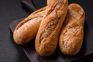 Crispy mini baguette with seeds and grains, salt and spices photo