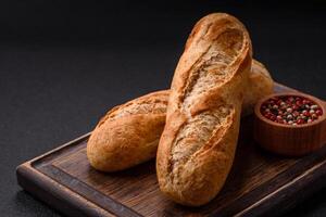 Crispy mini baguette with seeds and grains, salt and spices photo