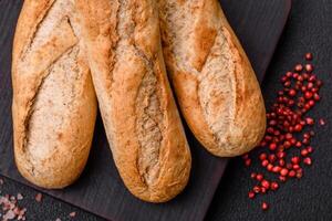 Crispy mini baguette with seeds and grains, salt and spices photo