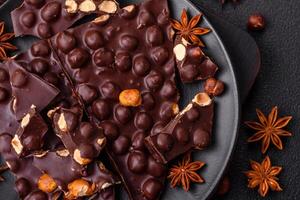 Black bitter chocolate with whole hazelnuts, candied fruits and mint photo