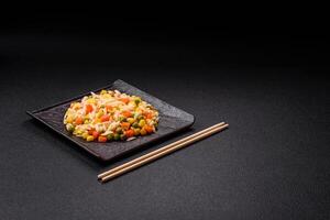 Delicious boiled rice with vegetables corn, carrots, peas with salt photo