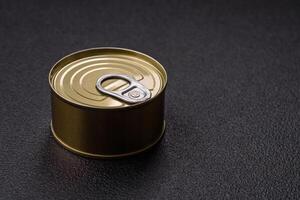 Round metal can with canned meat or fish with a key photo