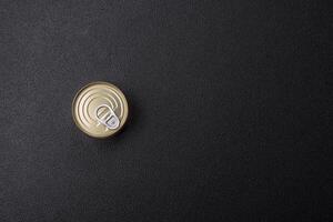 Round metal can with canned meat or fish with a key photo