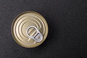 Round metal can with canned meat or fish with a key photo