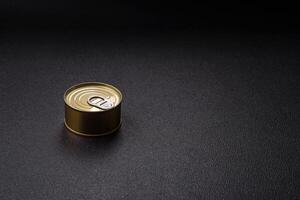 Round metal can with canned meat or fish with a key photo