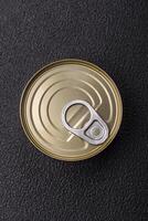 Round metal can with canned meat or fish with a key photo