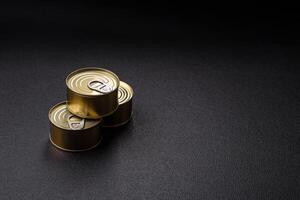 Round metal can with canned meat or fish with a key photo