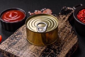 Round metal can with canned meat or fish with a key photo