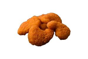 Delicious fresh crispy chicken nuggets on a dark concrete background photo