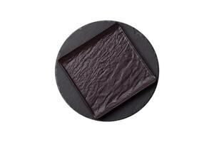 Empty round slate plate for template on the black background photo