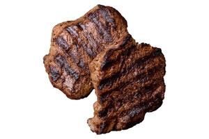 Fresh juicy delicious beef steak on a dark background photo