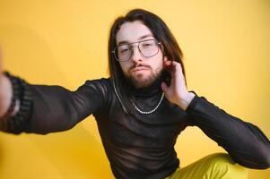 Gay man on a colored background in the studio. The concept of the LGBTQ community. Equality. photo