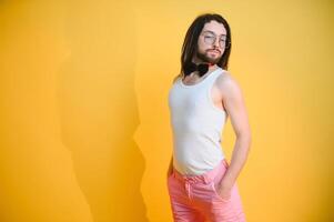 Gay man on a colored background in the studio. The concept of the LGBTQ community. Equality. photo