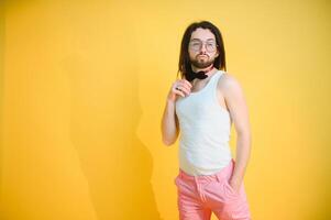 Gay man on a colored background in the studio. The concept of the LGBTQ community. Equality. photo