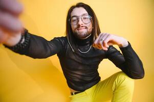 Gay man on a colored background in the studio. The concept of the LGBTQ community. Equality. photo