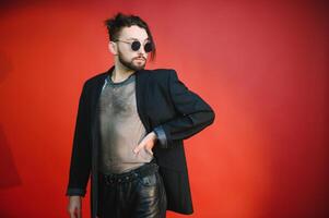 Gay man on a colored background in the studio. The concept of the LGBTQ community. Equality. photo