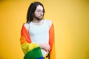 Youth transgender LGBT with Rainbow flag on shoulder isolated color background. gender expression pride and equality concept. photo