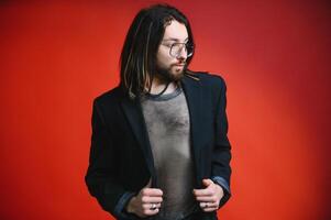 Young gay man is standing in the studio and posing for a camera. photo