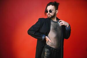 Young, handsome gay man on a colored background in the studio. LGBT concept. photo