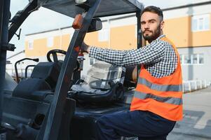 Waving forklift driver in the warehouse of a haulage company while driving forklift photo