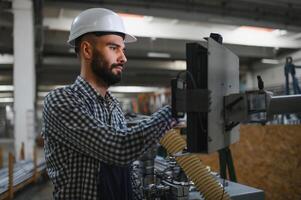 worker operating machine in factory photo