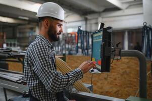 worker operating machine in factory photo