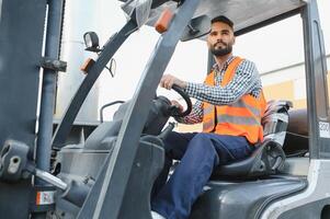 Waving forklift driver in the warehouse of a haulage company while driving forklift photo