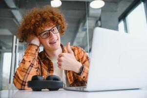 Stylish male freelancer working on new startup project making internet researchers analyzing data using laptop photo