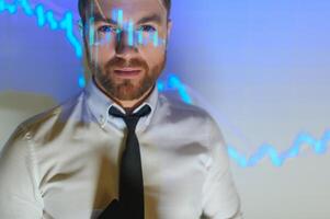 Stock Market Trader Working Investment Charts, Graphs, Ticker, Diagrams Projected on His Face. Financial Analyst and Digital Businessman Selling Shorts and Buying Longs photo