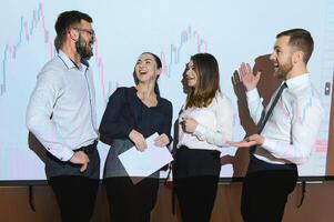 Group of business people working. Technical price graph and indicator, red and blue candlestick chart and stock trading computer screen background. Traders analyzing data photo