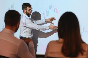 Analyzing data, graphs and reports for investment purposes. Creative teamwork traders. photo