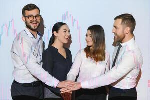 Group of business people working at modern office.Technical price graph, red and blue candlestick chart and stock trading computer screen background. Double exposure. Traders analyzing data photo