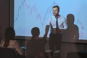 Group of business people working. Technical price graph and indicator, red and blue candlestick chart and stock trading computer screen background. Traders analyzing data photo