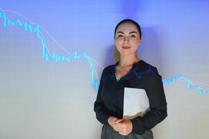 successful stocks and forex market trading - young beautiful and happy business woman and trader coaching investment strategies and financial success on candlesticks graph photo
