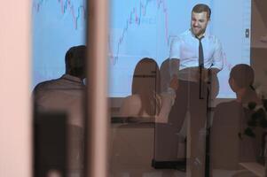Group of business people working at modern office.Technical price graph, red and blue candlestick chart and stock trading computer screen background. Double exposure. Traders analyzing data photo
