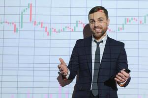 Stock Market Trader Working Investment Charts, Graphs, Ticker, Diagrams Projected on His Face. Financial Analyst and Digital Businessman Selling Shorts and Buying Longs photo