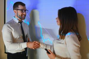 Group of business people working. Technical price graph and indicator, red and blue candlestick chart and stock trading computer screen background. Traders analyzing data photo