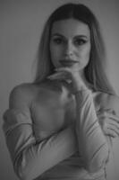 Sexy young woman. Girl posing on wall in studio. photo