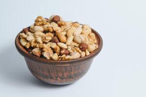 Mixed nuts on a plate. White background photo