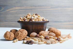Mixed nuts on wood floor. Organic and fresh nuts. Copy space photo